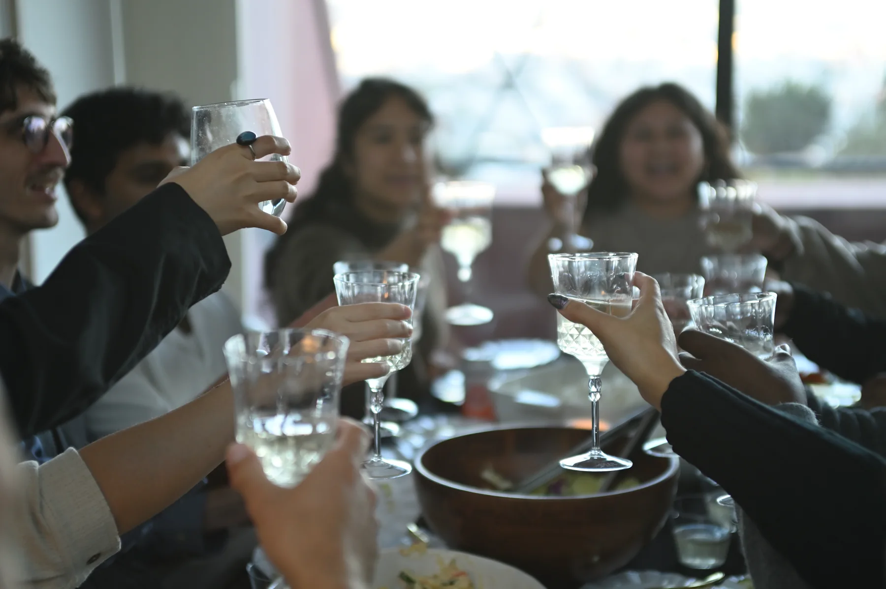 Guests raising glasses at Belonging.